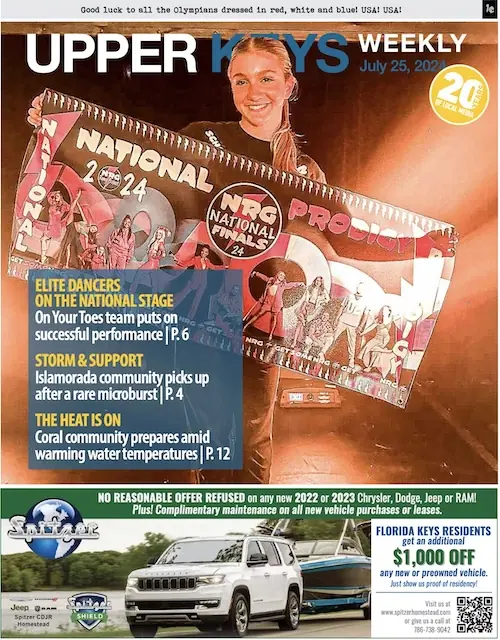 a magazine cover with a woman holding a sign